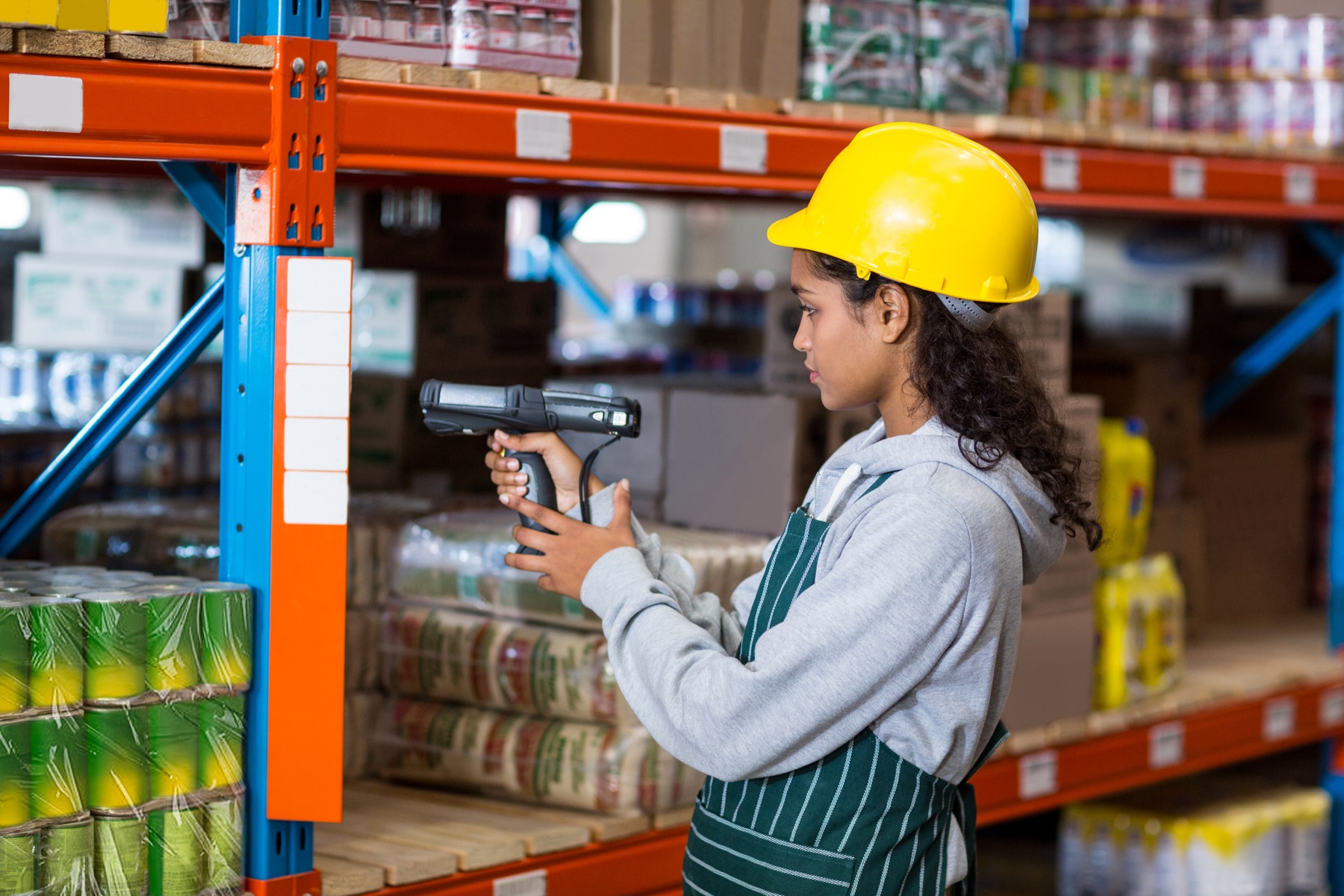 Warehouse worker scanning products to verify inventory storage location